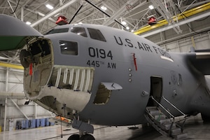 Plane in maintenance bay getting repairs.