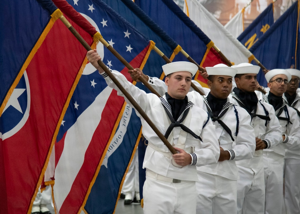 GREAT LAKES, Ill. (July 23, 2026) – Recruits assigned to the state flags unit display flags inside Midway Ceremonial Drill Hall during pass-in-review onboard U.S. Navy Recruit Training Command in Great Lakes, July 23, 2026. Training is approximately nine weeks and all enlistees in the U.S. Navy begin their career at the command. More than 40,000 recruits train annually at the Navy’s only boot camp. (U.S. Navy photo by Mass