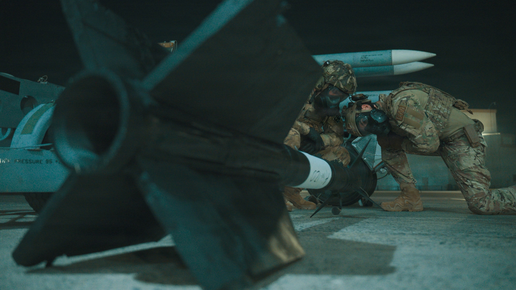 Service members handling ammunition.