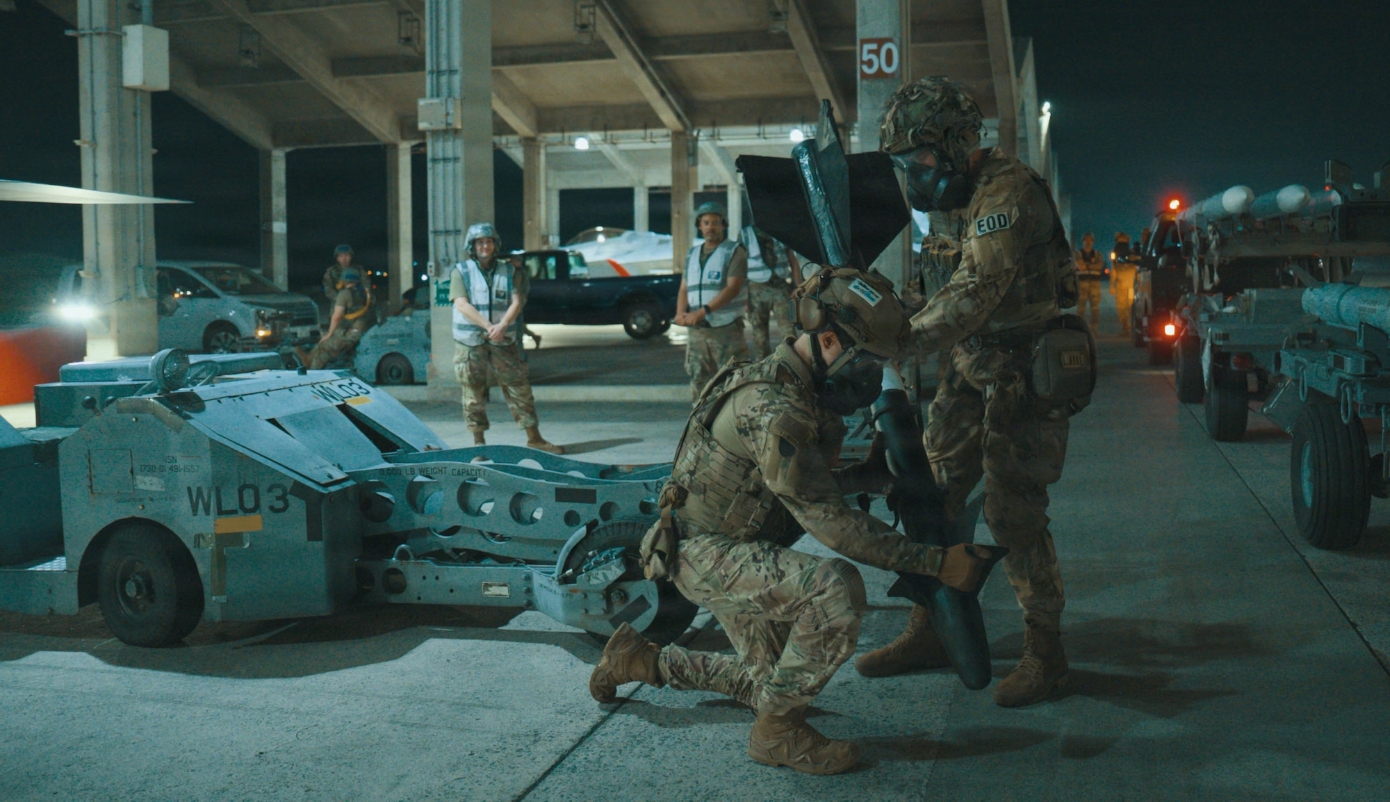 Service members handling ammunition.