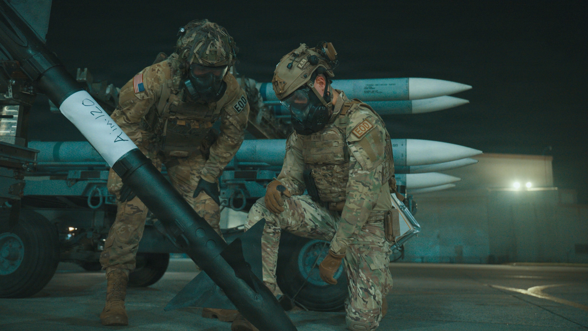 Service members handling ammunition.