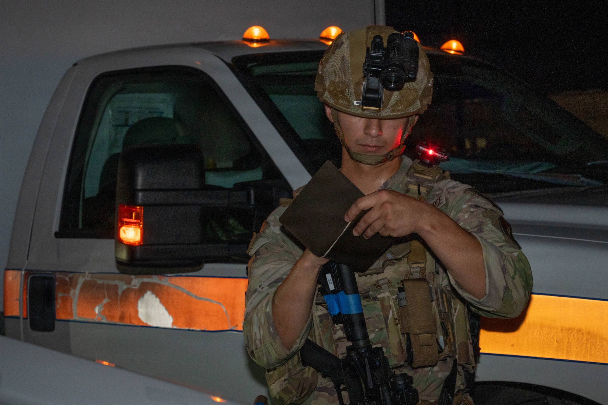 Service member writes on notebook.