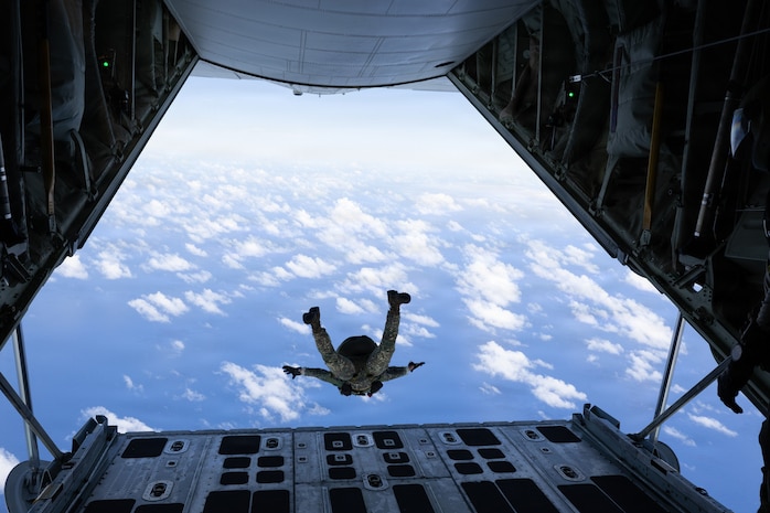 A Philippine Marine Corps member jumps out of a U.S. Marine Corps KC-130J Hercules aircraft assigned to Marine Aerial Refueler Transport Squadron (VMGR) 153 during military free fall jump training as a part of Exercise Rim of the Pacific 2026 above Marine Corps Base Hawaii, July 17, 2026.