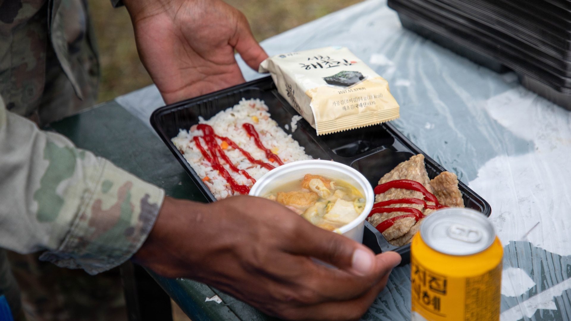 A U.S. Army Soldier assigned to 2nd Infantry Division, ROK-US Combined Division, receives a breakfast prepared by Republic of Korea Army soldiers during a Combined Field Feeding Training Exercise at Rodriguez Live Fire Complex, South Korea, July 28, 2026.