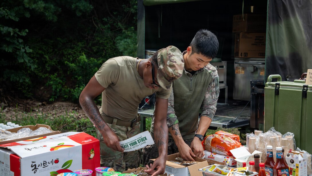 U.S. Army Pfc. Messiah McCuff, assigned to the 541st Field Feeding Company, 19th Expeditionary Sustainment Command and Republic of Korea Army Cpl. Jidam Choi, assigned to the 56th Infantry Division, prepare a meal during a Combined Field Feeding Training Exercise at Rodriguez Live Fire Complex, South Korea, July 27, 2026.