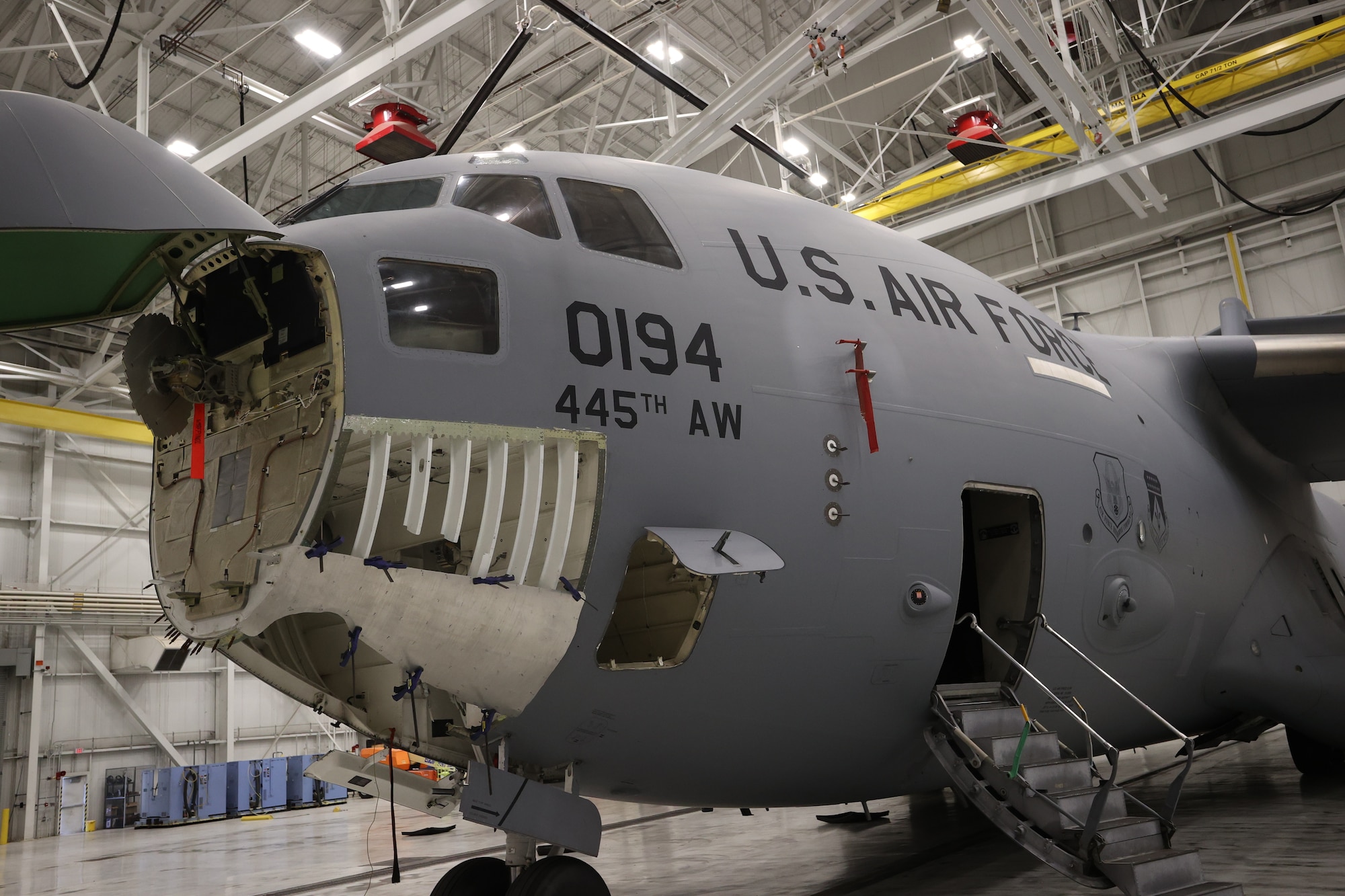 Plane in maintenance bay getting repairs.