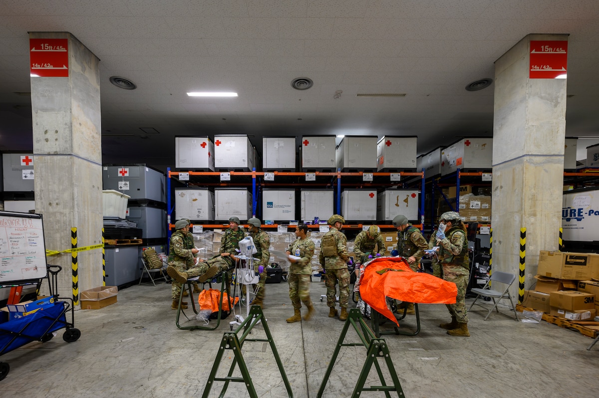 U.S. Air Force medical personnel assigned to the 18th Medical Group provide care to simulated patients during an En-Route Patient Staging System exercise as part of Beverly Beach 26-1 at Kadena Air Base, Japan, Aug. 4, 2026. The exercise tested the unit's ability to receive, stabilize and prepare patients for aeromedical evacuation in an expeditionary environment. (U.S. Air Force photo by Airman 1st Class Francisco Huerta)