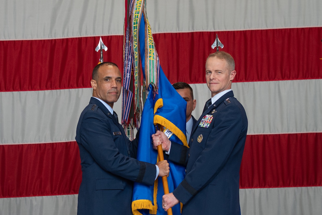 U.S. Air Force Gen. Adrian Spain, commander of Air Combat Command, receives the ceremonial guidon from U.S. Air Force Lt. Gen. Derek France, outgoing U.S. Air Forces Central commander, during a change of command ceremony at Shaw Air Force Base, South Carolina, Aug. 4, 2026.