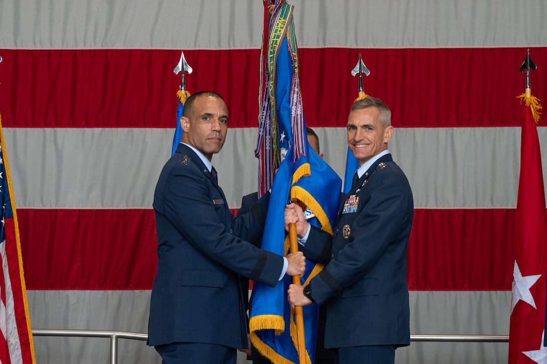 U.S. Air Force Gen. Adrian Spain, commander of Air Combat Command, receives the ceremonial guidon from U.S. Air Force Lt. Gen. Derek France, outgoing U.S. Air Forces Central commander, during a change of command ceremony at Shaw Air Force Base, South Carolina, Aug. 4, 2026.