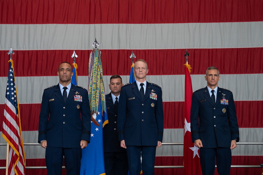 U.S. Air Force Gen. Adrian Spain, left, commander of Air Combat Command, U.S. Air Force Lt. Gen. Daniel T. Lasica, center, U.S. Air Forces Central incoming commander, and U.S. Air Force Lt. Gen. Derek France, right, outgoing Ninth Air Force (Air Forces Central) commander, celebrate on stage during a change of command ceremony at Shaw Air Force Base, South Carolina, Aug. 4, 2026.