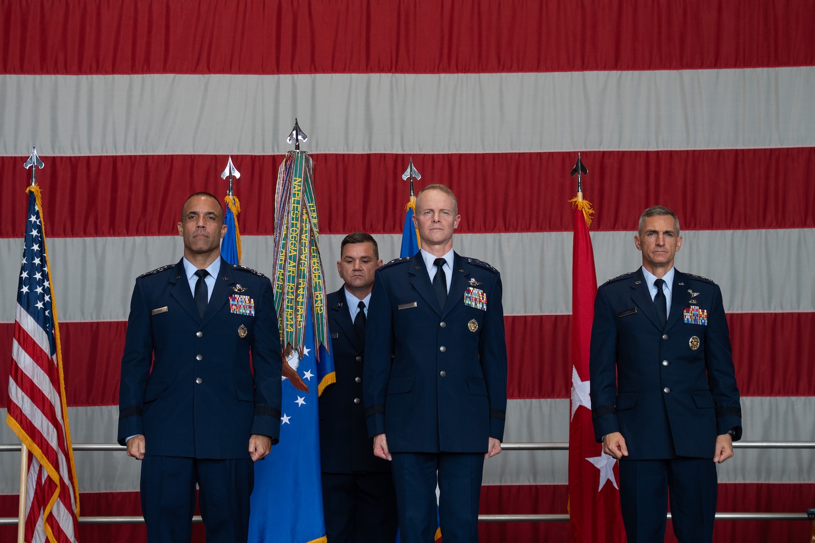 U.S. Air Force Gen. Adrian Spain, left, commander of Air Combat Command, U.S. Air Force Lt. Gen. Daniel T. Lasica, center, U.S. Air Forces Central incoming commander, and U.S. Air Force Lt. Gen. Derek France, right, outgoing Ninth Air Force (Air Forces Central) commander, celebrate on stage during a change of command ceremony at Shaw Air Force Base, South Carolina, Aug. 4, 2026.