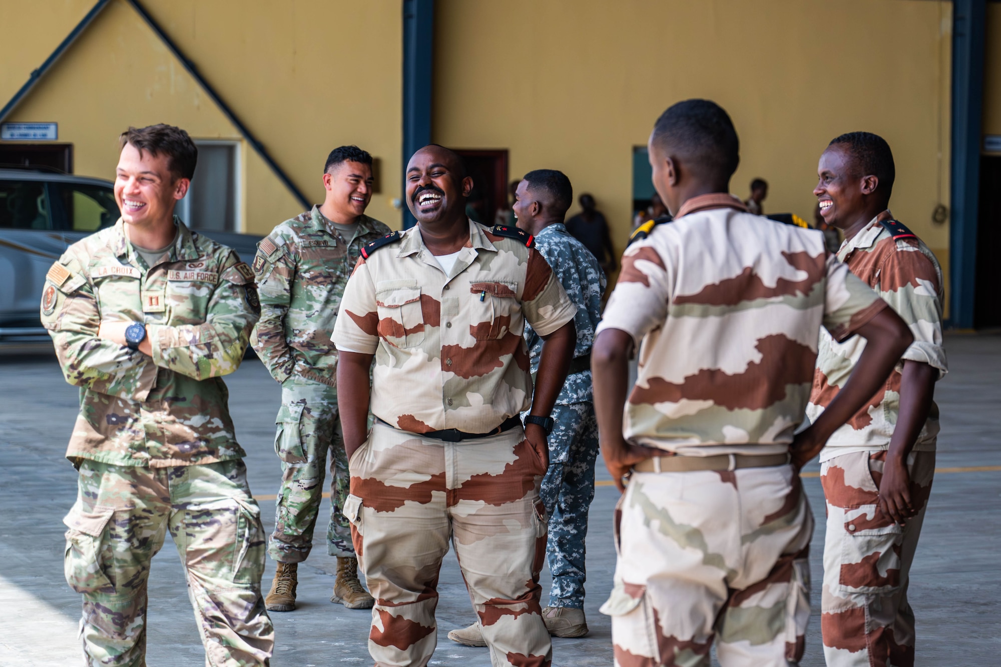 Military members share a laugh together.