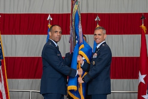 U.S. Air Force Gen. Adrian Spain, commander of Air Combat Command, receives the ceremonial guidon from U.S. Air Force Lt. Gen. Derek France, outgoing U.S. Air Forces Central commander, during a change of command ceremony at Shaw Air Force Base, South Carolina, Aug. 4, 2026.