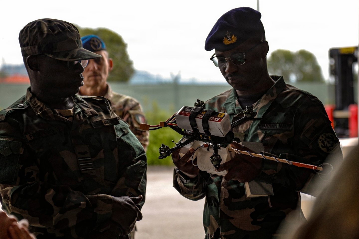 Ghana Armed Forces representatives inspect a drone during a showcase of unmanned aircraft systems innovation, technical management and production capabilities hosted by the U.S. Army Southern European Task Force, Africa, at the 173rd Mobile Brigade Combat Team’s Bayonet Innovation Team drone lab on Caserma Del Din in Vicenza, Italy, July 22, 2026. The visit gave the Ghanaian delegation a firsthand look at how the U.S. Army designs, builds and maintains small unmanned aircraft at the tactical level, including the brigade’s in-house production. The exchange also advanced a partnership that provides insight into operating drones in extreme heat, informing U.S. system design and supporting readiness and lethality in different environments. The engagement complements the Africa Multidomain Training and Experimentation Center effort in Morocco, a U.S. Africa Command and Morocco initiative to help standardize drone proficiency and shared operational understanding among African nations. (U.S. Army photo by Staff Sgt. Catessa Palone)