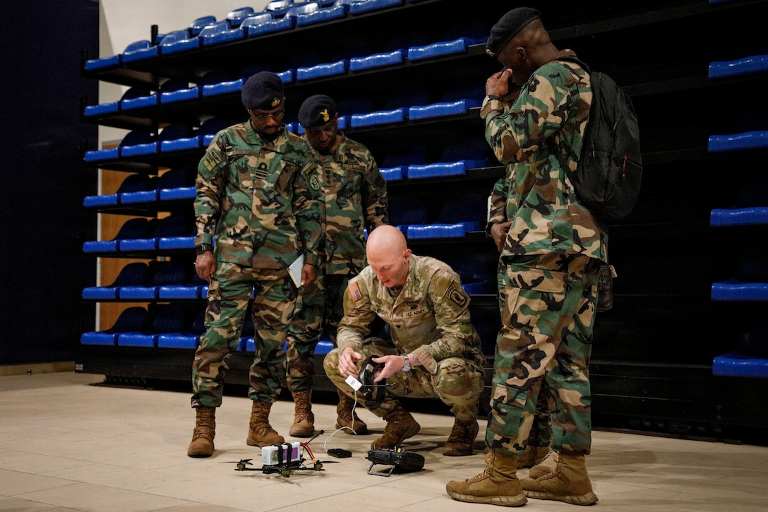 U.S. Army Spc. Aiden Sheridan, drone operator, 173rd Mobile Brigade Combat Team (Airborne), demonstrates flying techniques to members of the Ghana Armed Forces during a showcase of unmanned aircraft systems innovation at Caserma Del Din, Vicenza, Italy, July 22, 2026. The visit gave the Ghana delegation a firsthand look at how the U.S. Army designs, builds, and maintains small unmanned aircraft at the tactical level, including the 173rd MBCT’s in-house production. The exchange also advanced a partnership that provides insight into operating drones in extreme heat, informing U.S. system design and sustaining readiness and lethality in different environments.