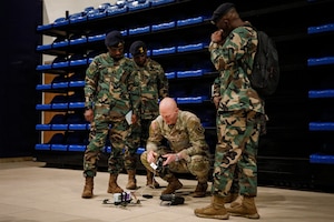 U.S. Army Spc. Aiden Sheridan, drone operator, 173rd Mobile Brigade Combat Team (Airborne), demonstrates flying techniques to members of the Ghana Armed Forces during a showcase of unmanned aircraft systems innovation at Caserma Del Din, Vicenza, Italy, July 22, 2026. The visit gave the Ghana delegation a firsthand look at how the U.S. Army designs, builds, and maintains small unmanned aircraft at the tactical level, including the 173rd MBCT’s in-house production. The exchange also advanced a partnership that provides insight into operating drones in extreme heat, informing U.S. system design and sustaining readiness and lethality in different environments.