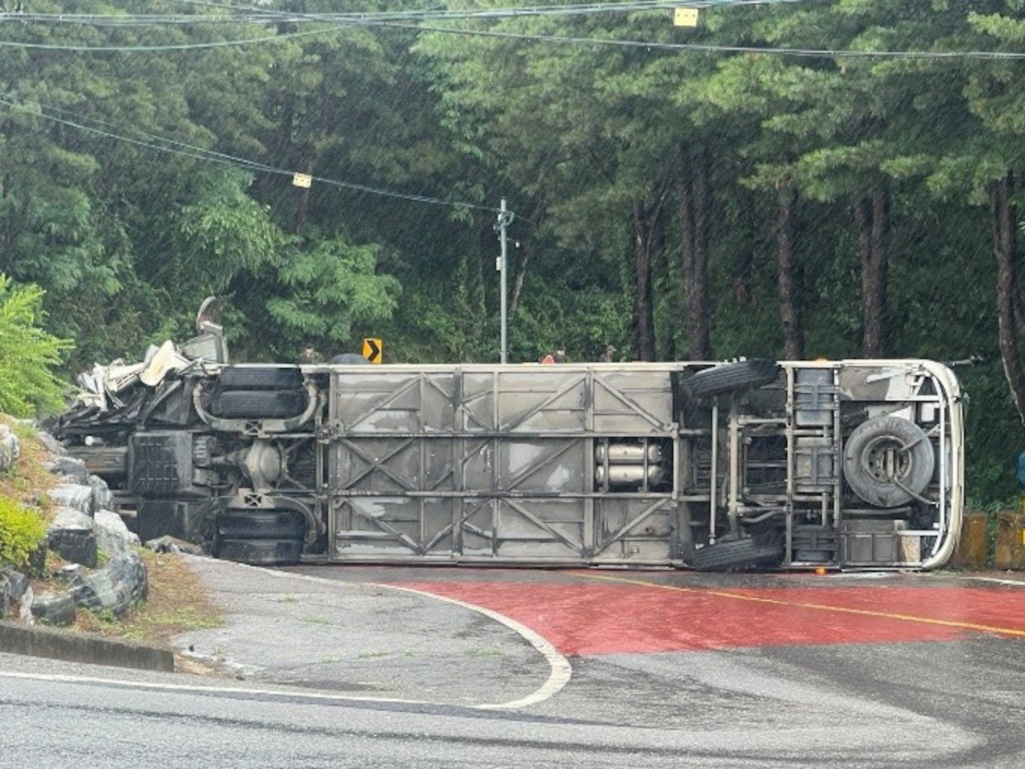 A tour bus sits overturned on a roadway in Paju, Republic of Korea, June 20, 2026. Off-duty U.S. Airmen and Soldiers sprang into action after the bus overturned, assisting injured passengers until emergency services arrived.
