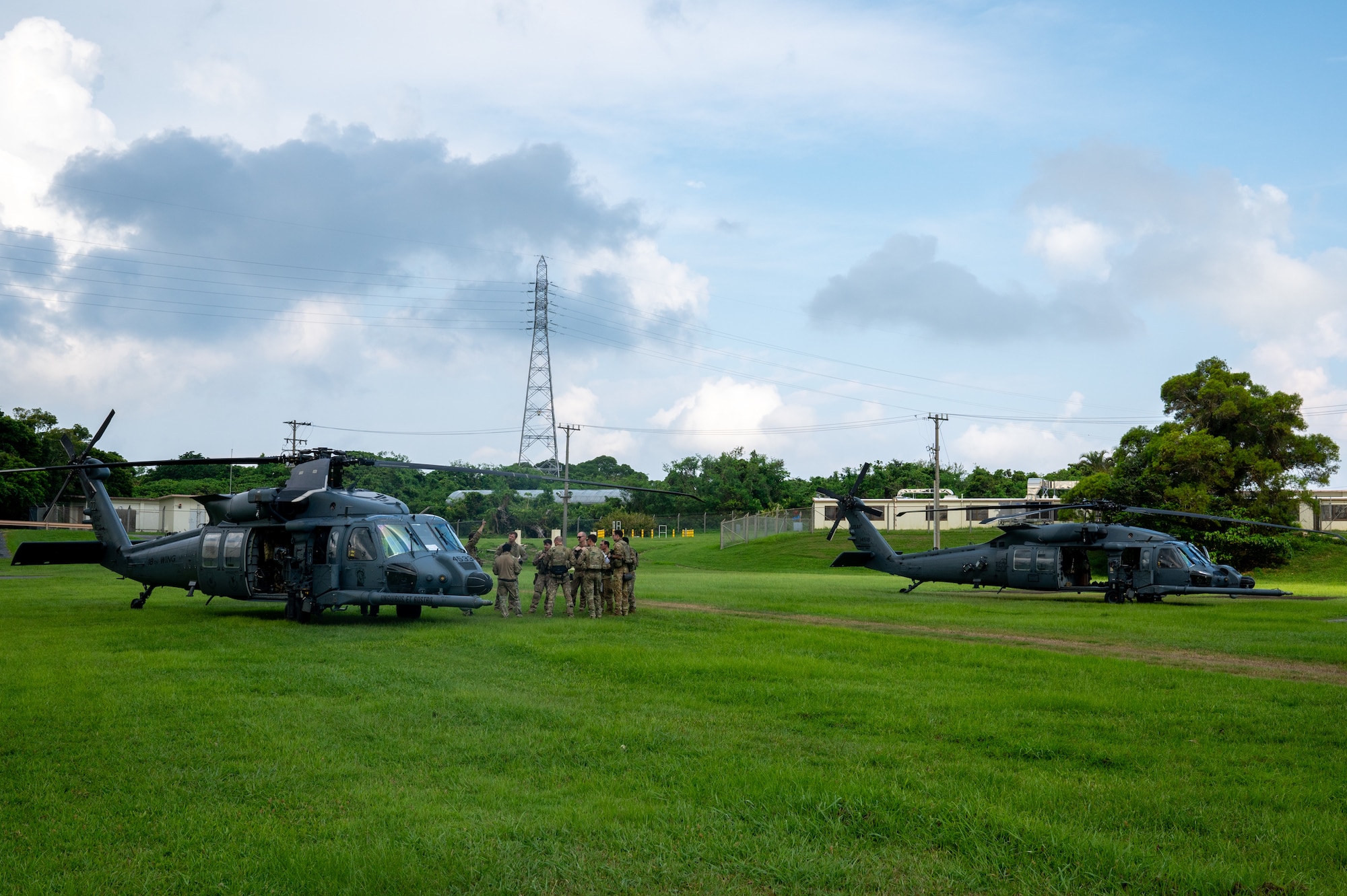 2 helicopters land on a field