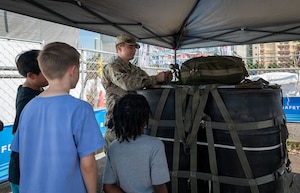 U.S. Air Force Airmen, assigned to the 374th Logistics Readiness Squadron combat mobility flight, and children from the Yokota Child Development Center participate in an airdrop operations workshop at Yokota Air Base, Japan, July 30, 2026.