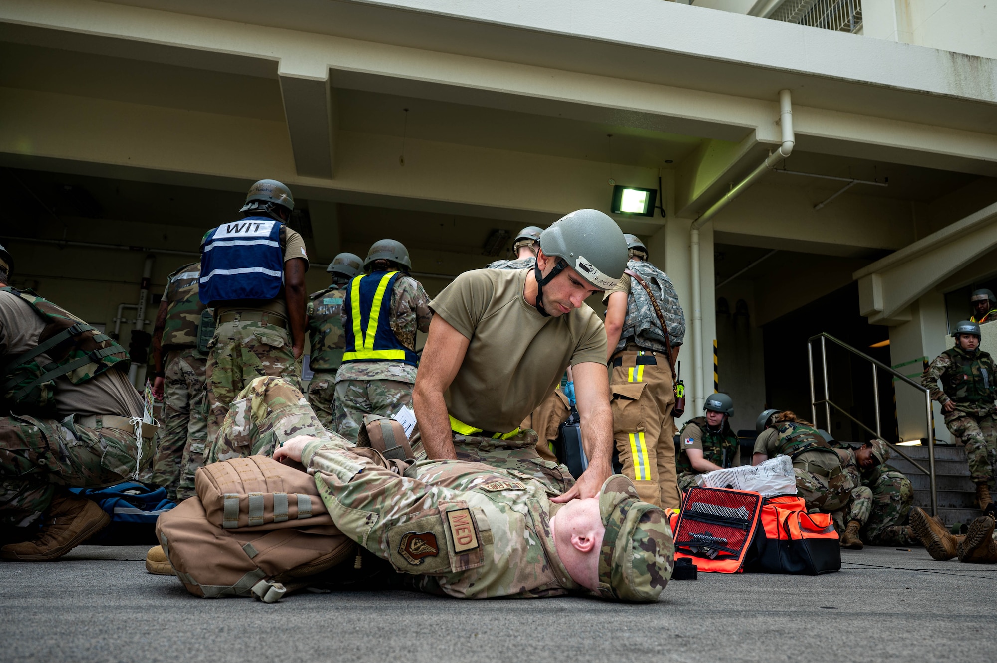 Service member assesses simulated patient.