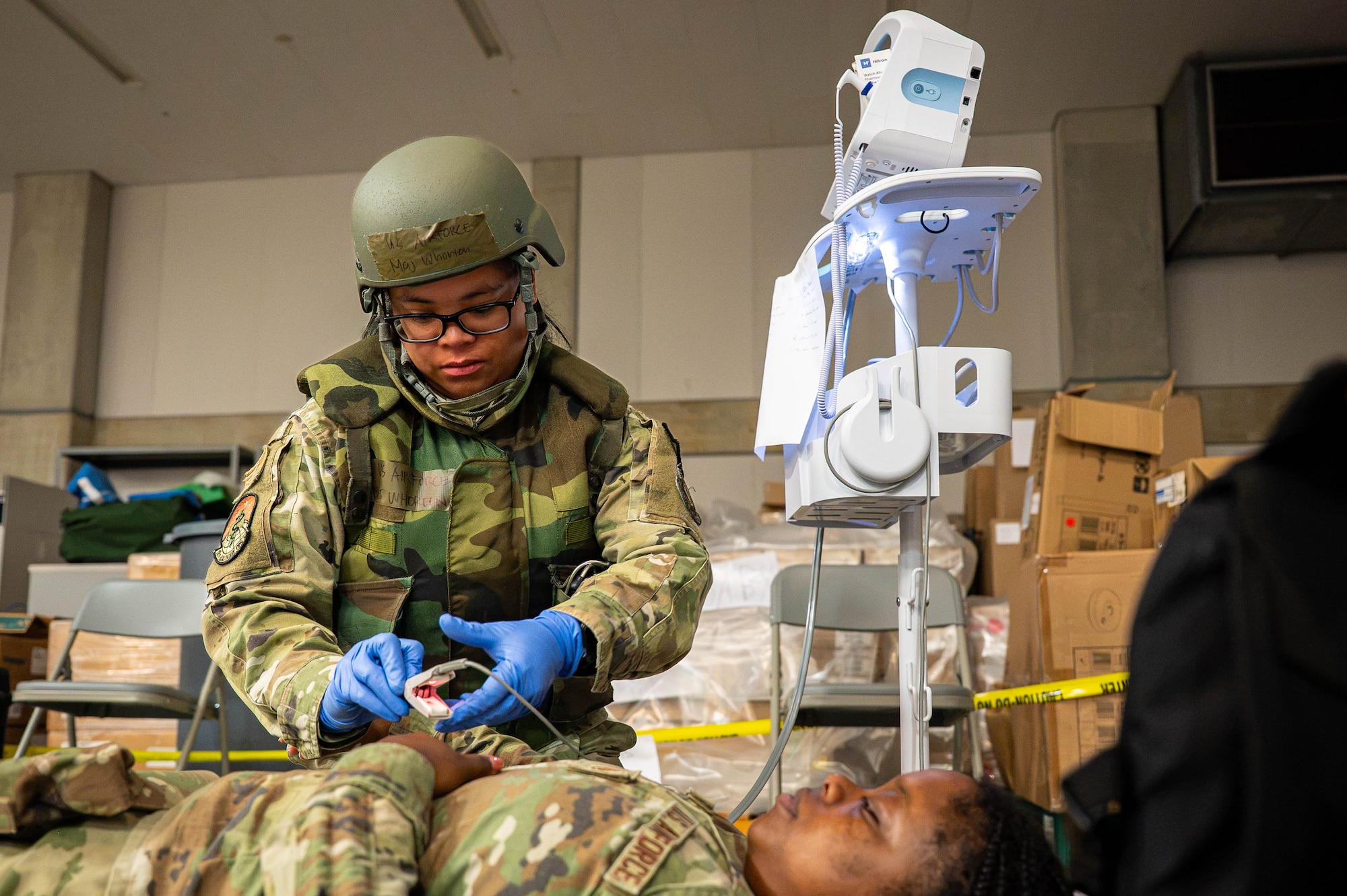 Service member assesses a simulated patient.