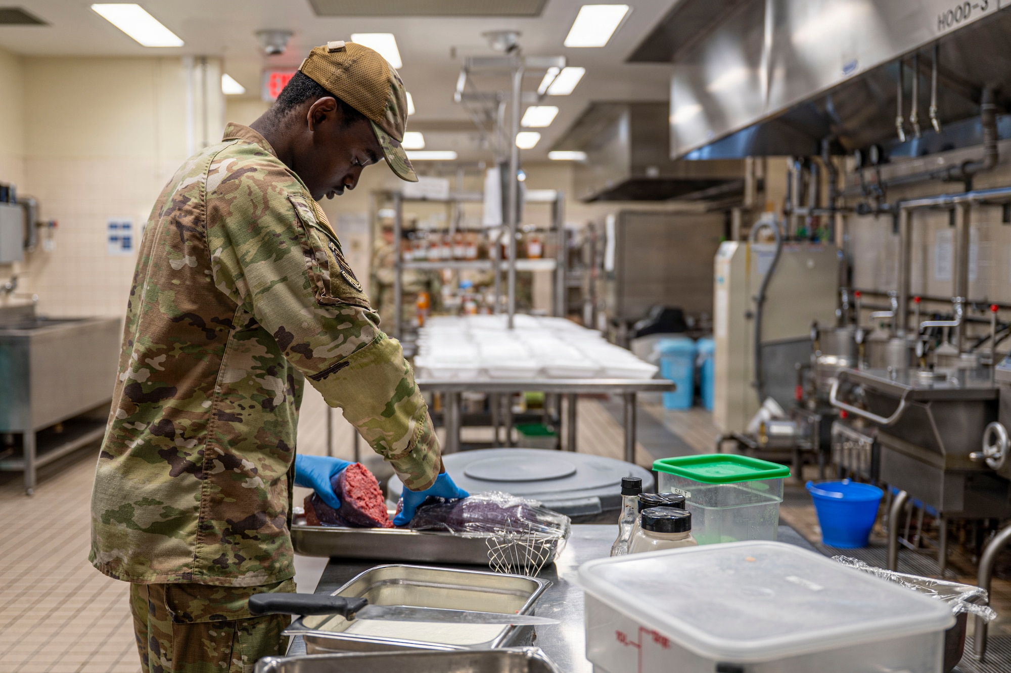 A person prepares food in an industrial kitchen