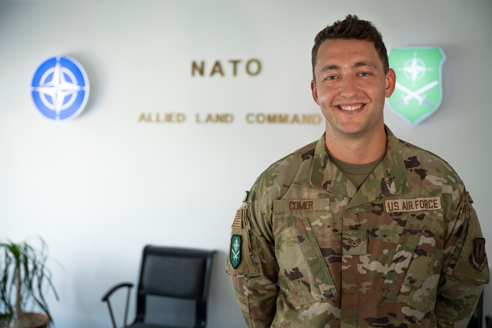 person standing, smiling