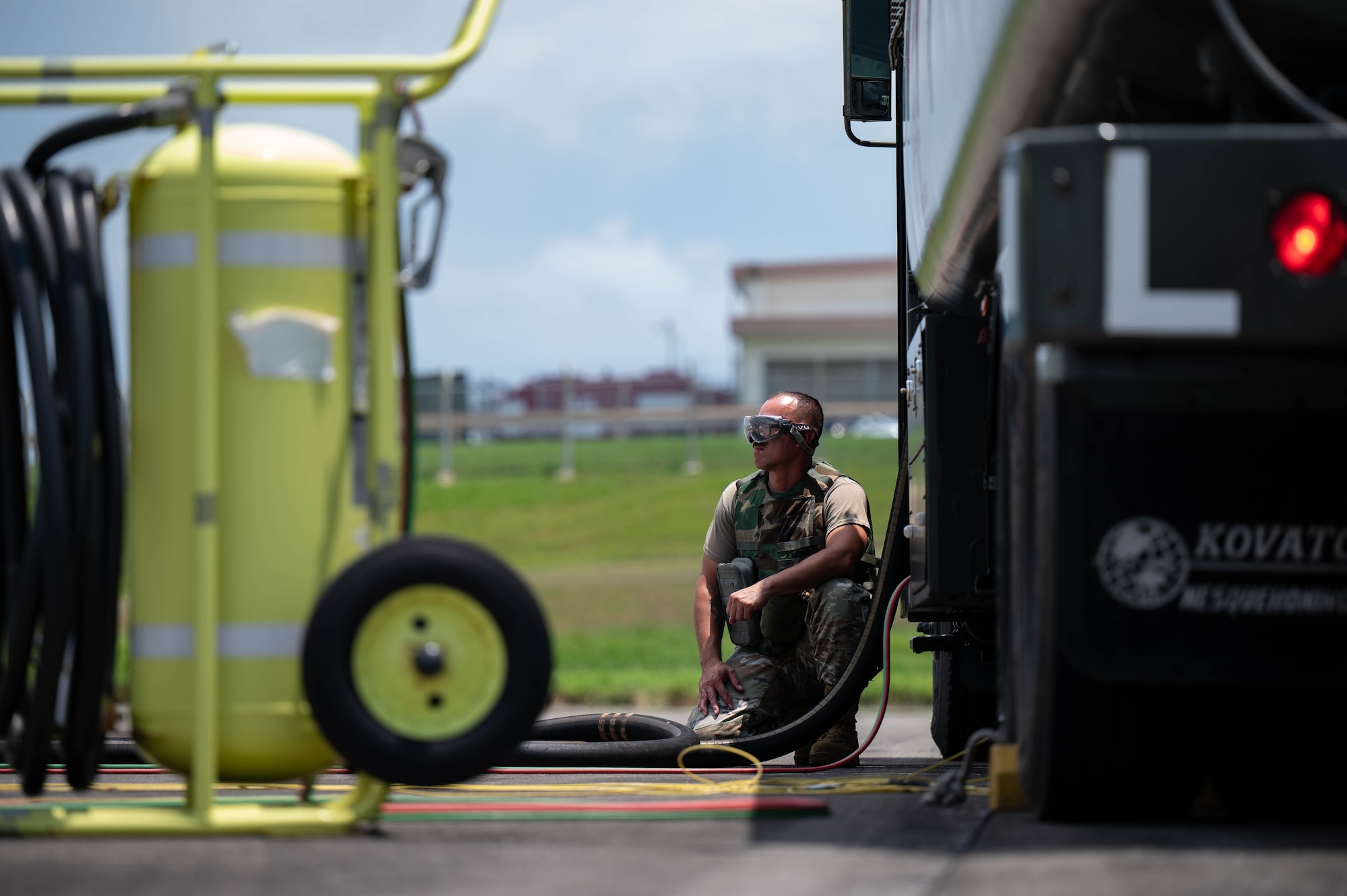 U.S. Air Force Airman 1st Class Joshua Vasquez, 18th Logistics Readiness Squadron petroleum, oil and lubricants distribution operator, monitors an HH-60W Jolly Green II while operating a fuel truck during a hot-gas refueling operation as part of readiness exercise Beverly Beach 26-1 at Kadena Air Base, Japan, Aug. 4, 2026. Readiness exercises such as BB26-1 strengthen the 18th Wing's ability to generate combat airpower by validating expeditionary logistics capabilities in realistic training scenarios. (U.S. Air Force photo by Airman 1st Class Nathaniel Jackson) (U.S. Air Force photo by Airman 1st Class Nathaniel Jackson)