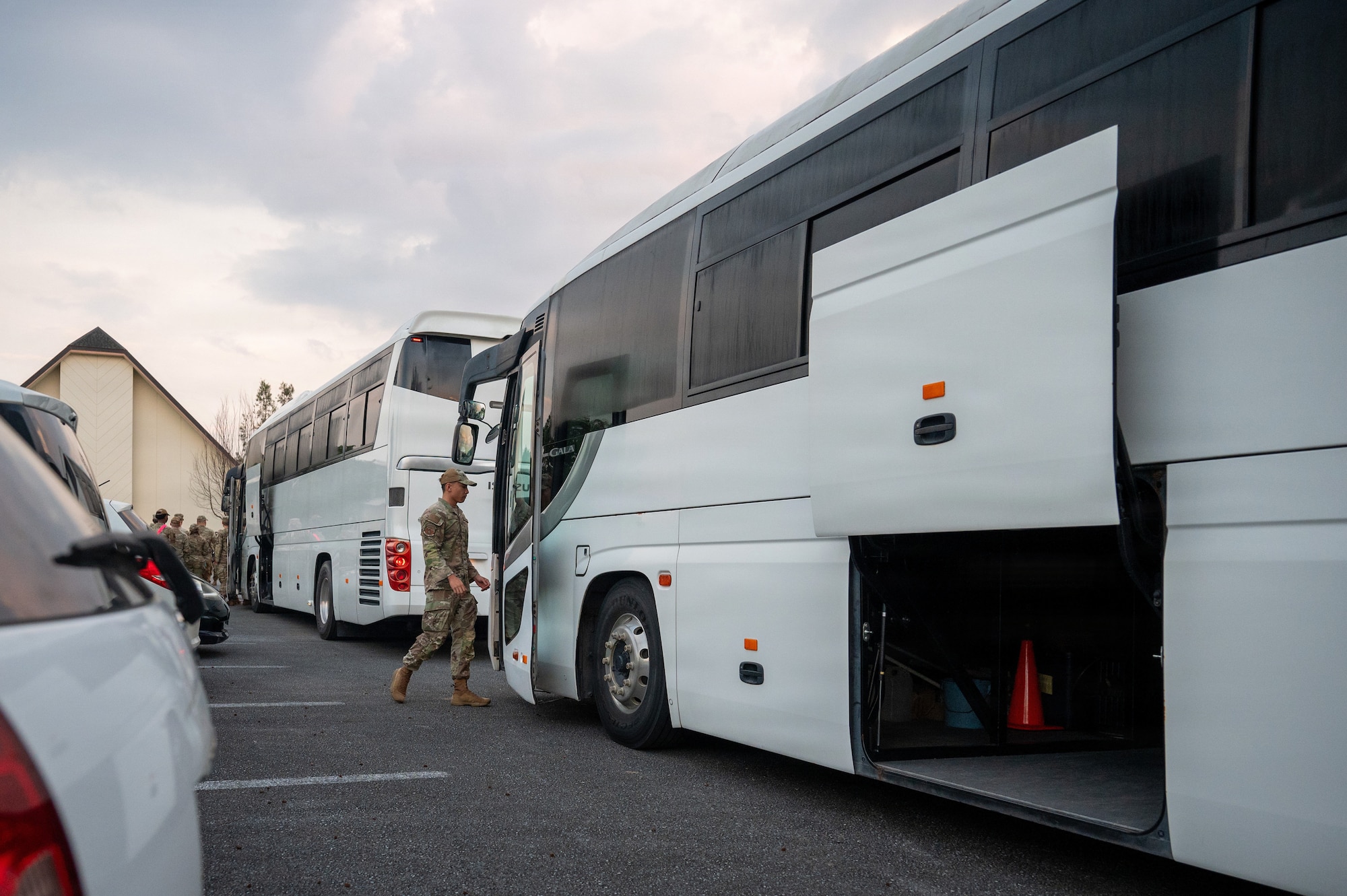 An Airman walks towards a bus during readiness exercise