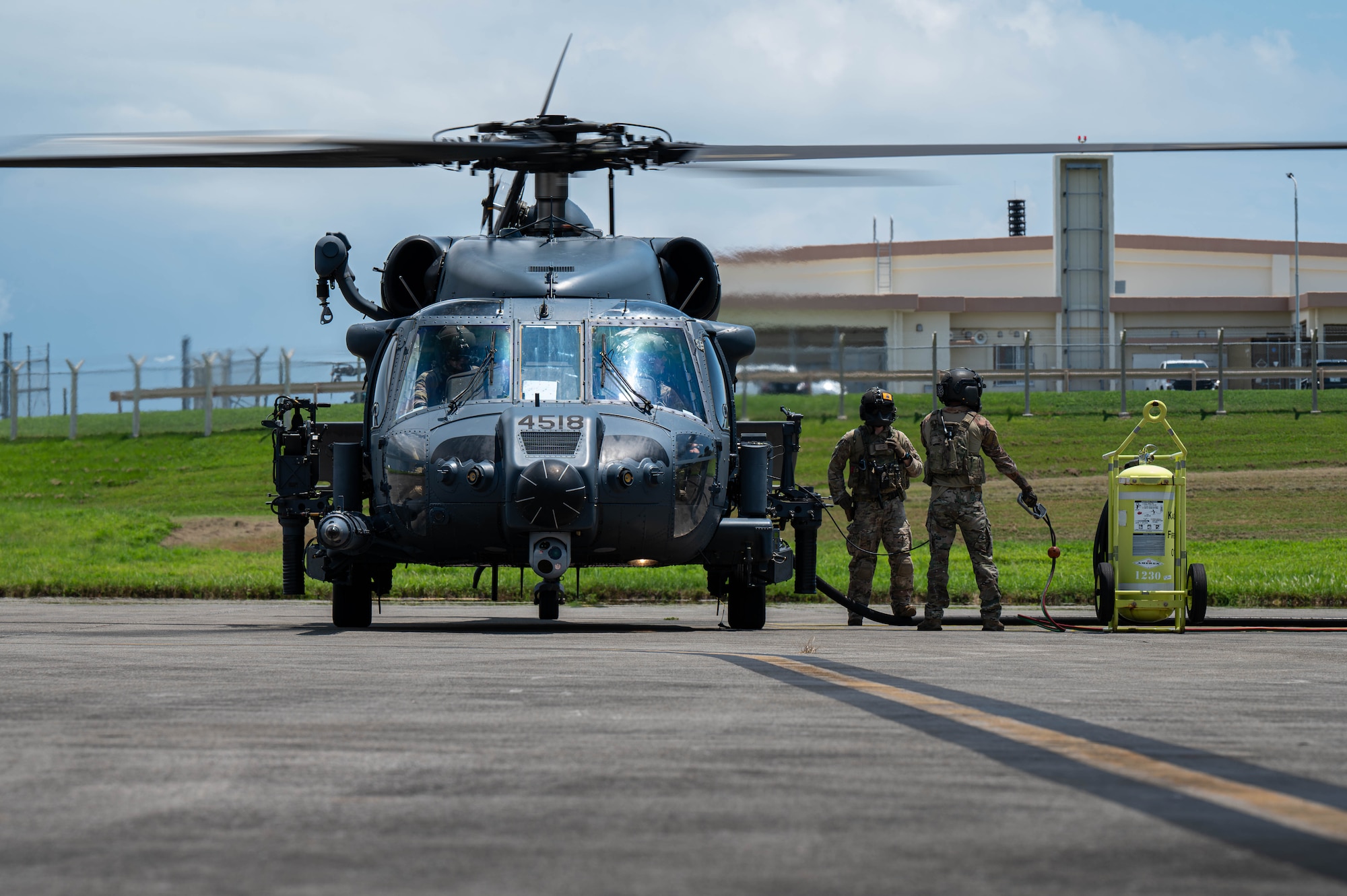 U.S. Air Force special mission aviators assigned to the 33rd Rescue Squadron refuel a U.S. Air Force HH-60W Jolly Green II during a hot-gas refueling operation as part of readiness exercise Beverly Beach 26-1 at Kadena Air Base, Japan, Aug. 4, 2026. BB26-1 provides Airmen opportunities to refine expeditionary operations and strengthen the 18th Wing's ability to generate combat airpower in contested environments. (U.S. Air Force photo by Airman 1st Class Nathaniel Jackson)