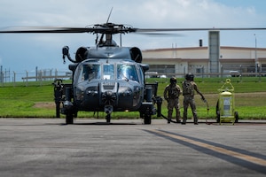 U.S. Air Force special mission aviators assigned to the 33rd Rescue Squadron refuel a U.S. Air Force HH-60W Jolly Green II during a hot-gas refueling operation as part of readiness exercise Beverly Beach 26-1 at Kadena Air Base, Japan, Aug. 4, 2026. BB26-1 provides Airmen opportunities to refine expeditionary operations and strengthen the 18th Wing's ability to generate combat airpower in contested environments. (U.S. Air Force photo by Airman 1st Class Nathaniel Jackson)