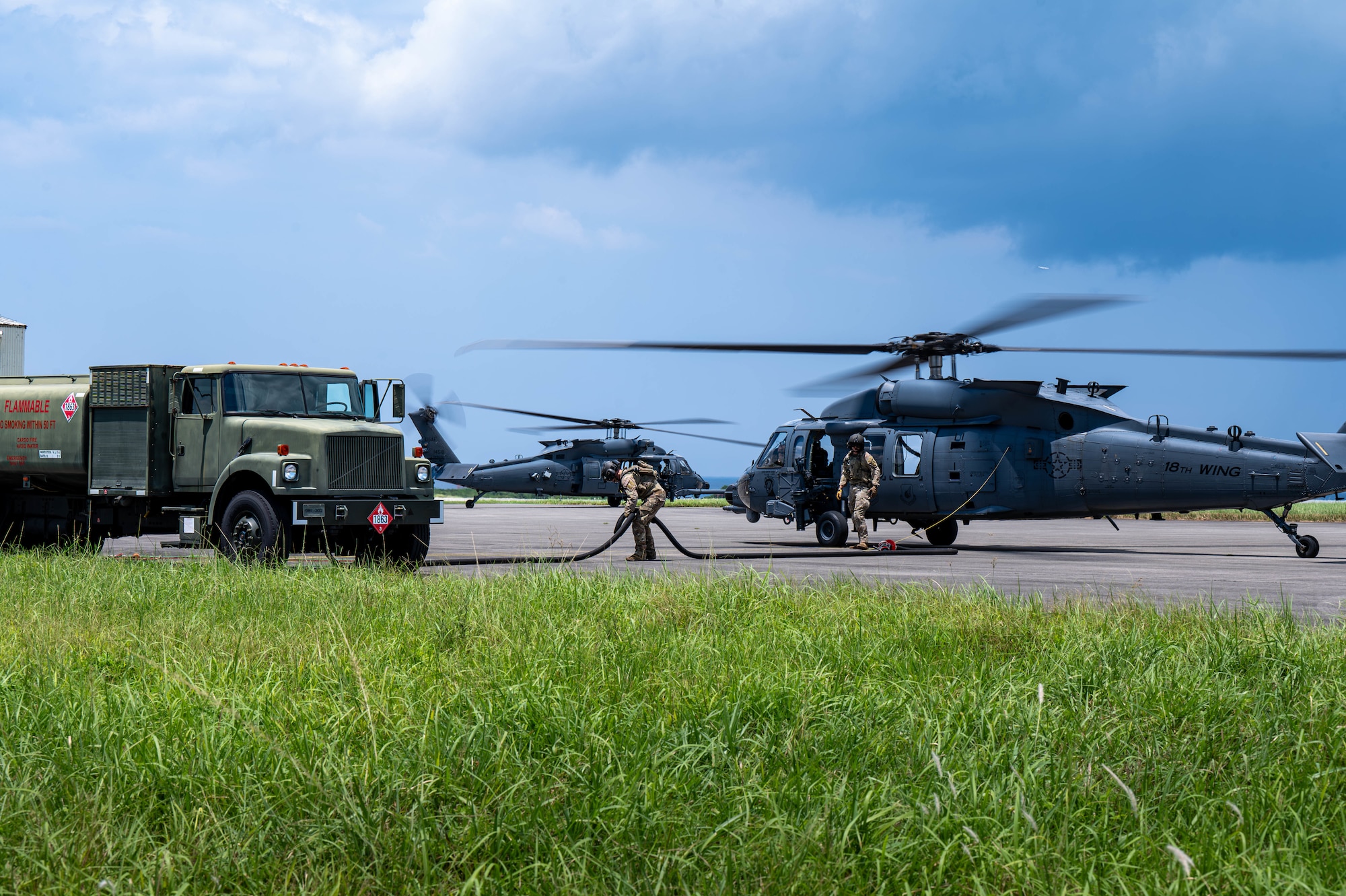 U.S. Air Force special mission aviators assigned to the 33rd Rescue Squadron refuel a U.S. Air Force HH-60W Jolly Green II during a hot-gas refueling operation as part of readiness exercise Beverly Beach 26-1 at Kadena Air Base, Japan, Aug. 4, 2026. BB26-1 provides Airmen opportunities to refine expeditionary operations and strengthen the 18th Wing's ability to generate combat airpower in contested environments. (U.S. Air Force photo by Airman 1st Class Nathaniel Jackson)