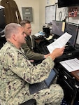 ABOARD USS ESSEX — Lt. Harley Sheffield, Naval Medical Forces Pacific chief nursing informatics officer and the Joint Operational Medicine Information Systems (JOMIS) Clinical Data Provider (CDP) assessment action officer (left), and HMCS William Meyers, USS Essex (LHD 2) medical department lead chief petty officer, work together during an assessment of the JOMIS CDP aboard the amphibious assault ship USS Essex. The evaluation, which ran from May 18 – 28, 2026, is part of a broader Department of War initiative to deploy modern, interoperable electronic health records to operational forces and ensure warfighter readiness. (Courtesy photo)