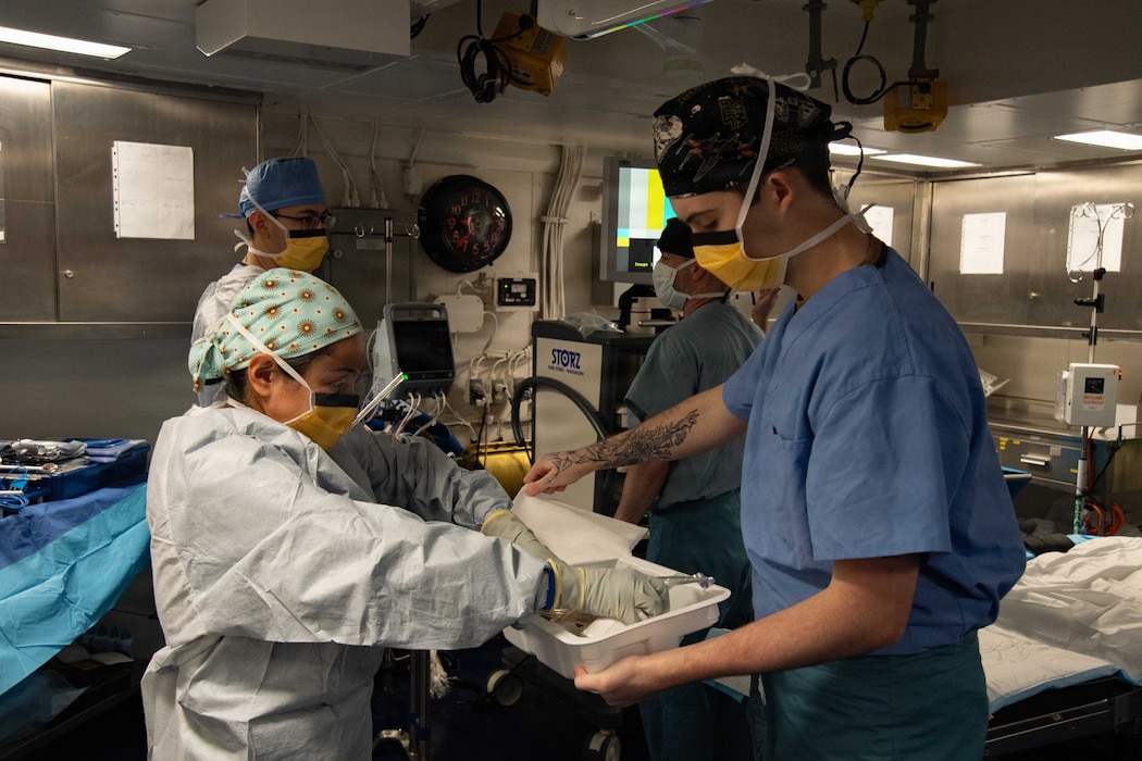 260629-N-MH008-1021 U.S. Navy Hospital Corpsman 2nd Class Cynthia Mejia Astorga, left, assigned to Fleet Surgical Team 3, and Hospital Corpsman 3rd Class Landon Adams, assigned to Wasp-class amphibious assault ship USS Boxer (LHD 4), prepare sterile equipment for a laparoscopic surgery in one of Boxer’s operating rooms while transiting the Indian Ocean, June 29, 2026. Boxer, flagship of the Boxer Amphibious Ready Group, is underway with the 11th Marine Expeditionary Unit in the U.S. 7th Fleet area of operations. U.S. 7th Fleet, the Navy’s largest forward-deployed numbered fleet, routinely interacts and operates with allies and partners to preserve a free and open Indo-Pacific. (U.S. Navy photo by Mass Communication Specialist 2nd Class Tyler Miles)
