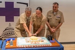 Rear Adm. Matthew Case, Acting Surgeon General and Director of the Medical Service Corps, Capt. David Lang, executive officer, Navy Medicine Readiness and Training Center and Lt. Adrianna Kuechle take part in the ceremonial cake cutting during a MSC Birthday Ceremony at Walter Reed National Military Medical Center, August 4, 2026. NMRTC Bethesda's mission is to maximize warfighter performance through optimized medical readiness tailored to operational requirements; enhance the readiness of the medical force to sustain expeditionary medical capability; and train and develop the Navy Medicine Force. (U.S. Navy photo by Mass Communication Specialist Second Class Alec Kramer)