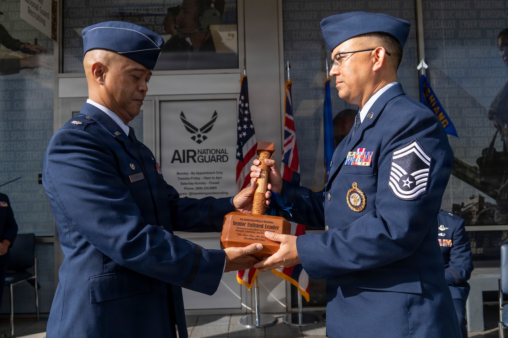 Air Force Lt. Col. Michael Buendia, Headquarters Hawaii Air National Guard Recruiting and Retention Flight commander, passes a ceremonial recruiting hammer to Senior Master Sgt. Todd Shak, Headquarters Hawaii Air National Guard Recruiting and Retention Flight senior enlisted leader, symbolizing Shak’s acceptance of responsibility as the senior enlisted leader of the flight during the unit's activation ceremony held at Pearl Highlands Center in Pearl City, Hawaii, Aug. 1, 2026.