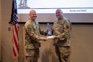 Maj. Michael Zimmer, a chaplain assigned to the 155th Air Refueling Wing, accepts the 2025 Samuel Stone Award by U.S. Air Force Col. Jonathan R. Bell, director of the Air National Guard Chaplain Corps, Aug. 1, 2026, at the Nebraska National Guard air base in Lincoln, Nebraska. This particular Department of the Air Force-level award recognizes one chaplain each year who demonstrates exceptional service, leadership and commitment to strengthening the spiritual readiness of Airmen and the communities they serve. (U.S. Air National Guard photo by Senior Airman Jeremiah Johnson)