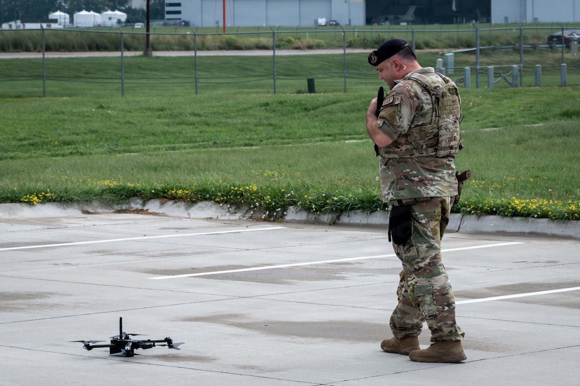 U.S. Air National Guard MSgt Ryan Blodgett, 155th Security Forces Squadron officer, radios information after the conclusion of a drone exercise July 30, 2026, at Nebraska National Guard air base, Lincoln, Nebraska. The exercise was a drill not only for Security Forces personnel, but the base personnel as well to test their situational awareness and knowledge of communication channels to report activity. (U.S. Air National Guard photo by TSgt Kevin Leahy)