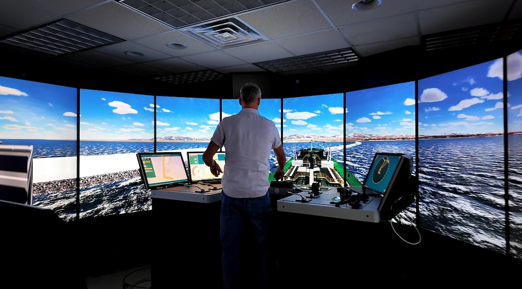 A pilot from the Port of Nome in Alaska navigates a vessel through a docking simulation during a recent experiment with the U.S. Army Watercraft and Ship Simulator.