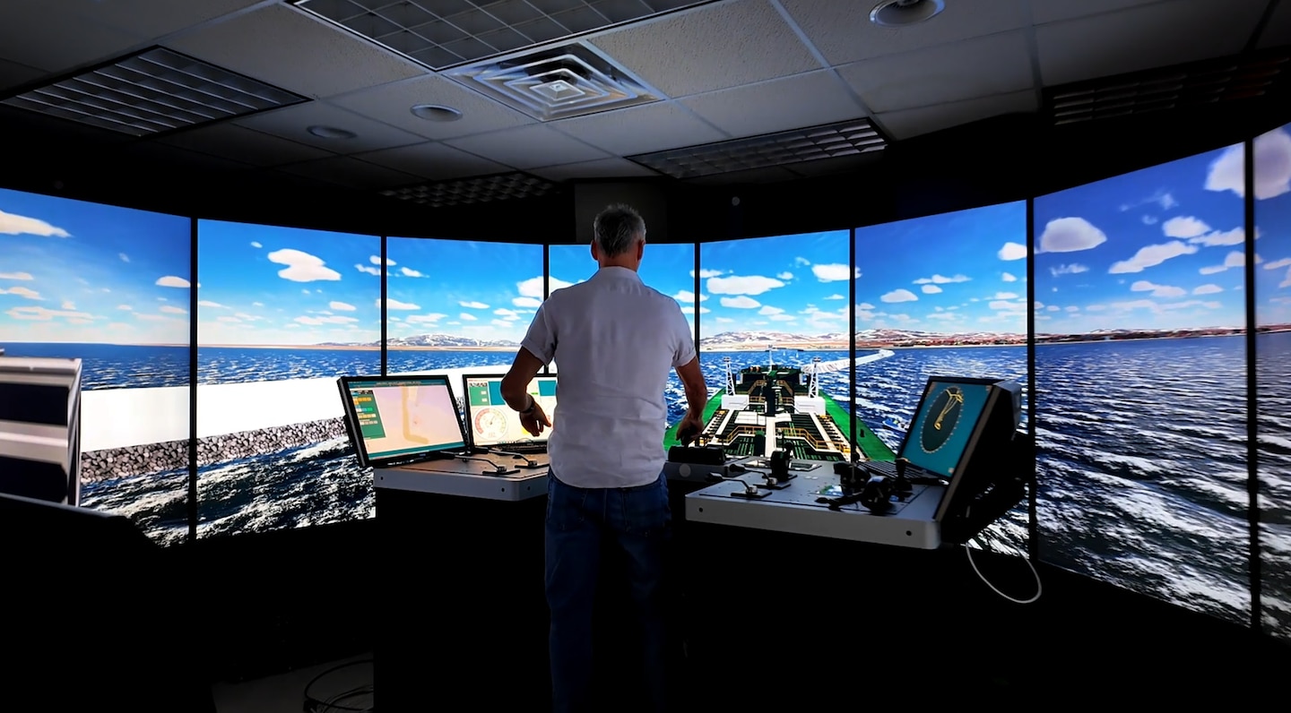A pilot from the Port of Nome in Alaska navigates a vessel through a docking simulation during a recent experiment with the U.S. Army Watercraft and Ship Simulator.