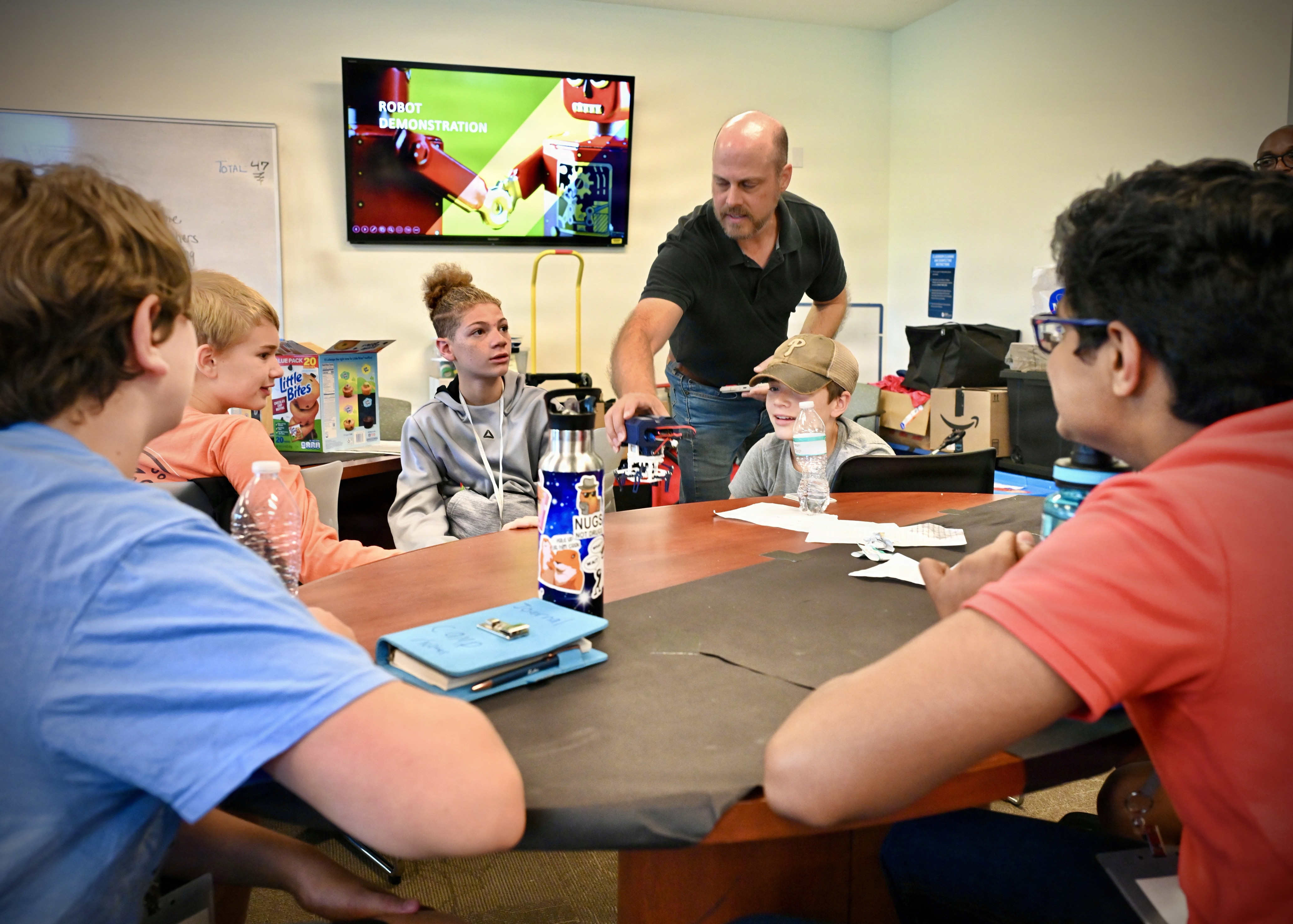 Middle school students participating in hands-on learning activities during NIWC Atlantic's 2026 Summer STEM Camp "To the Moon and Back" at Tidewater Community College.