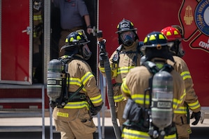 Firefighters with Arnold Air Force Base Fire and Emergency Services participate in live structure fire training April 15, 2026, at Arnold AFB, Tenn., headquarters of Arnold Engineering Development Complex. Fire and Emergency Services is a requirement of the Facility Support Services III contract set to be awarded in summer 2027. AEDC personnel hosted companies interested in bidding on the contact during an Industry Day event, July 21-22 at the Arnold AFB. (U.S. Air Force photo by Keith Thornburgh) (This image was altered by obscuring badges for security purposes)