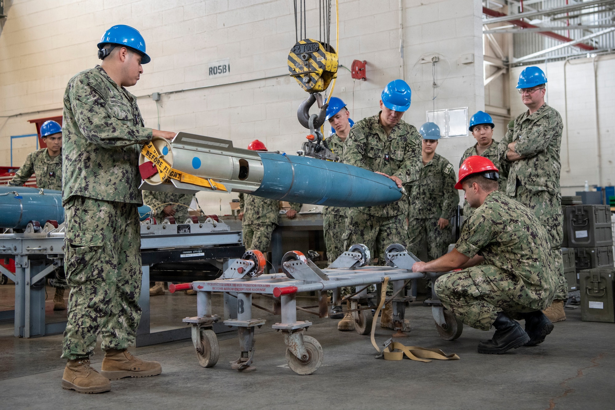 U.S. Navy minemen and gunner’s mates, attached to Navy Reserve (NR) Navy Munitions Command Pacific (NMCPAC) Mine Assembly Unit (MAU) Okinawa (OKI), lift an inert 500-pound Mark 62 Quickstrike mine to a transport cart during an assembly training evolution at Naval Weapons Station Seal Beach, California, July 12, 2026. NR NMCPAC MAU OKI conducted the assembly training to evaluate munitions readiness and strengthen reserve force integration within the U.S. Pacific Fleet area of operations. (U.S. Navy photo by Mass Communication Specialist 1st Class Bryan Ilyankoff)