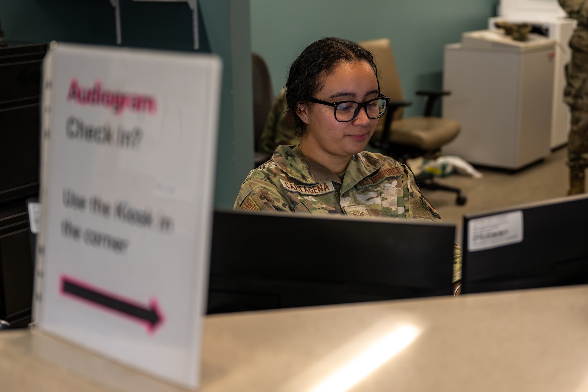 Airman working at a desk.