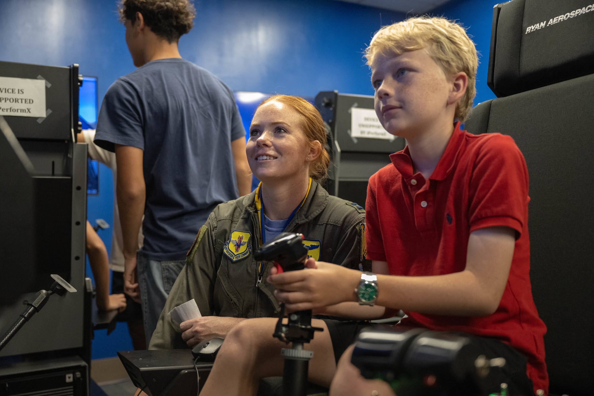 U.S. Air Force Capt. Keelyn Osoba, 85th Flying Training Squadron (FTS) instructor pilot, oversees a participant of Tiger for a Day piloting a flight simulator at Laughlin Air Force Base, Texas, Aug. 5, 2026. The 85th FTS allowed participants to experience the daily operations of the squadron. (U.S. Air Force photo by Airman 1st Class Darryl Keith)