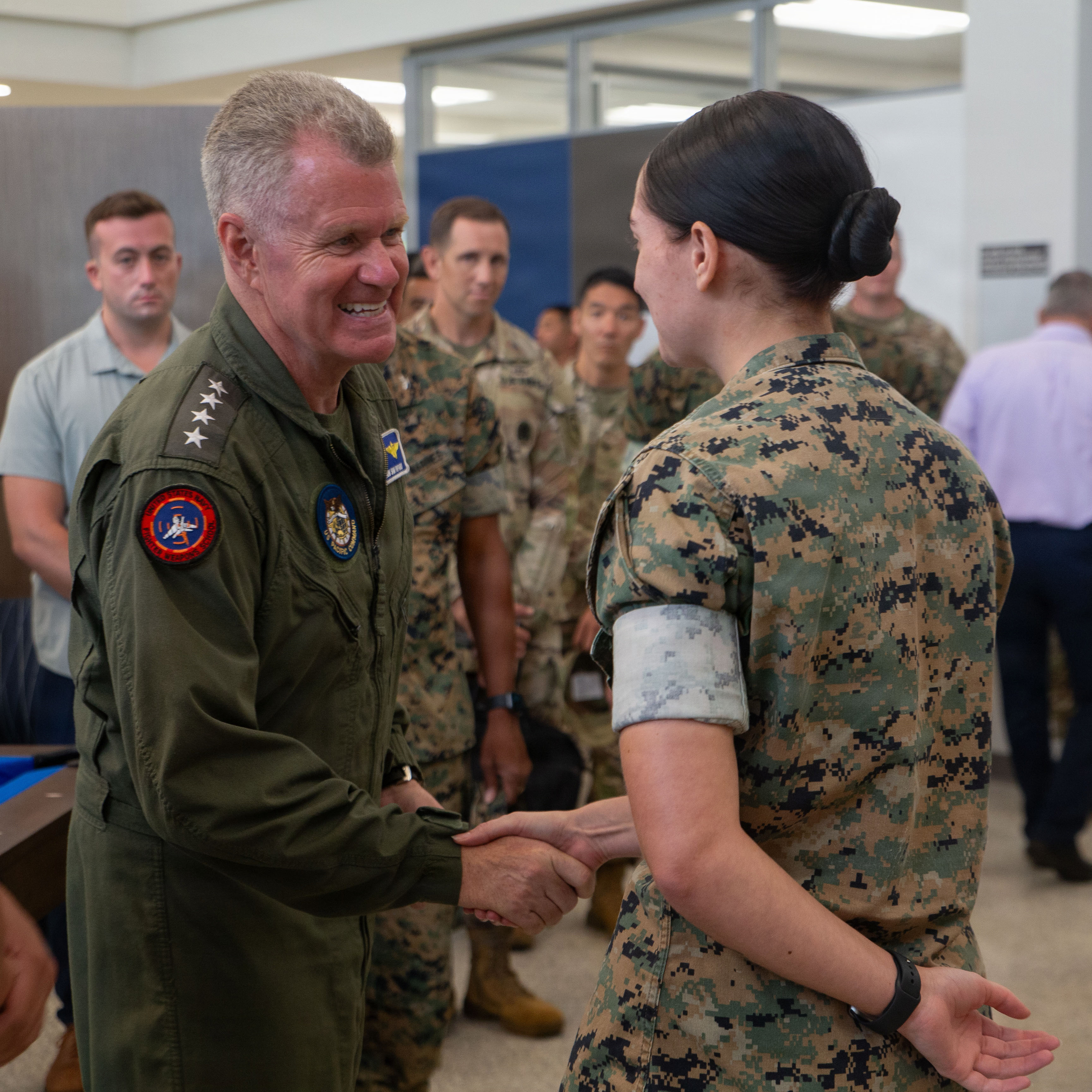 U.S. Navy Adm. Samuel Paparo, Commander, U.S. Indo-Pacific Command, shakes hands with U.S. Marine Corps Lance Cpl. Mazie Gebhart, blotter clerk, Headquarters Company, Marine Corps Base Camp Blaz, In the community core building, on MCB Camp Blaz, Guam, June 30, 2026. Adm. Paparo visited the installation to discuss future development for Camp Blaz. (U.S. Marine Corps photo by Lance Cpl. Tanner Currin)