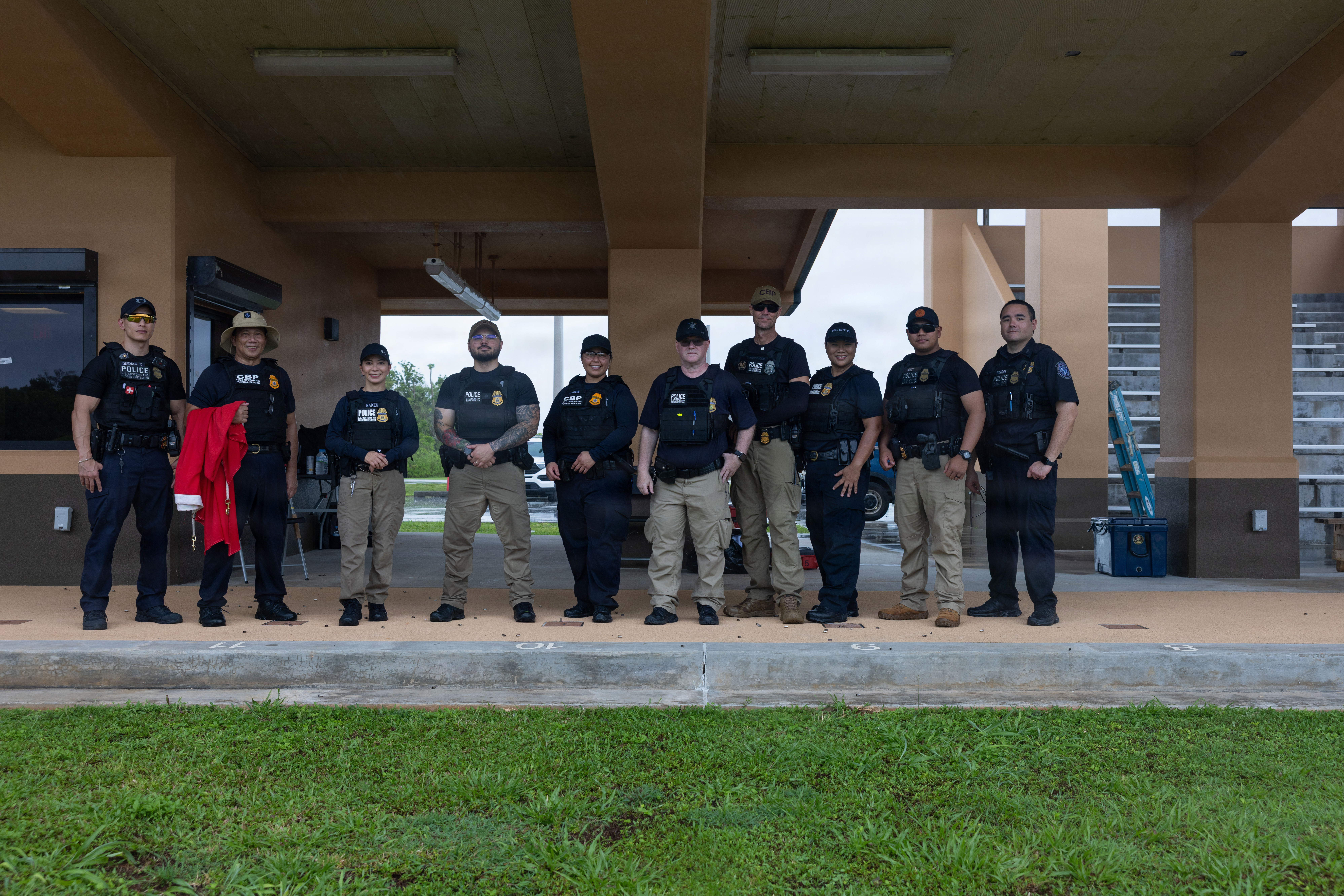 U.S. Customs and Border Protection officers pose for a group photo at Mason Live Fire Training Range Complex, Marine Corps Base Camp Blaz, Guam, June 26, 2026. CBP personnel completed standardized pistol qualification exercises to ensure weapons proficiency and operational readiness during emergency situations is maintained. (U.S. Marine Corps photo by Cpl. Rey Moreno Marilao)