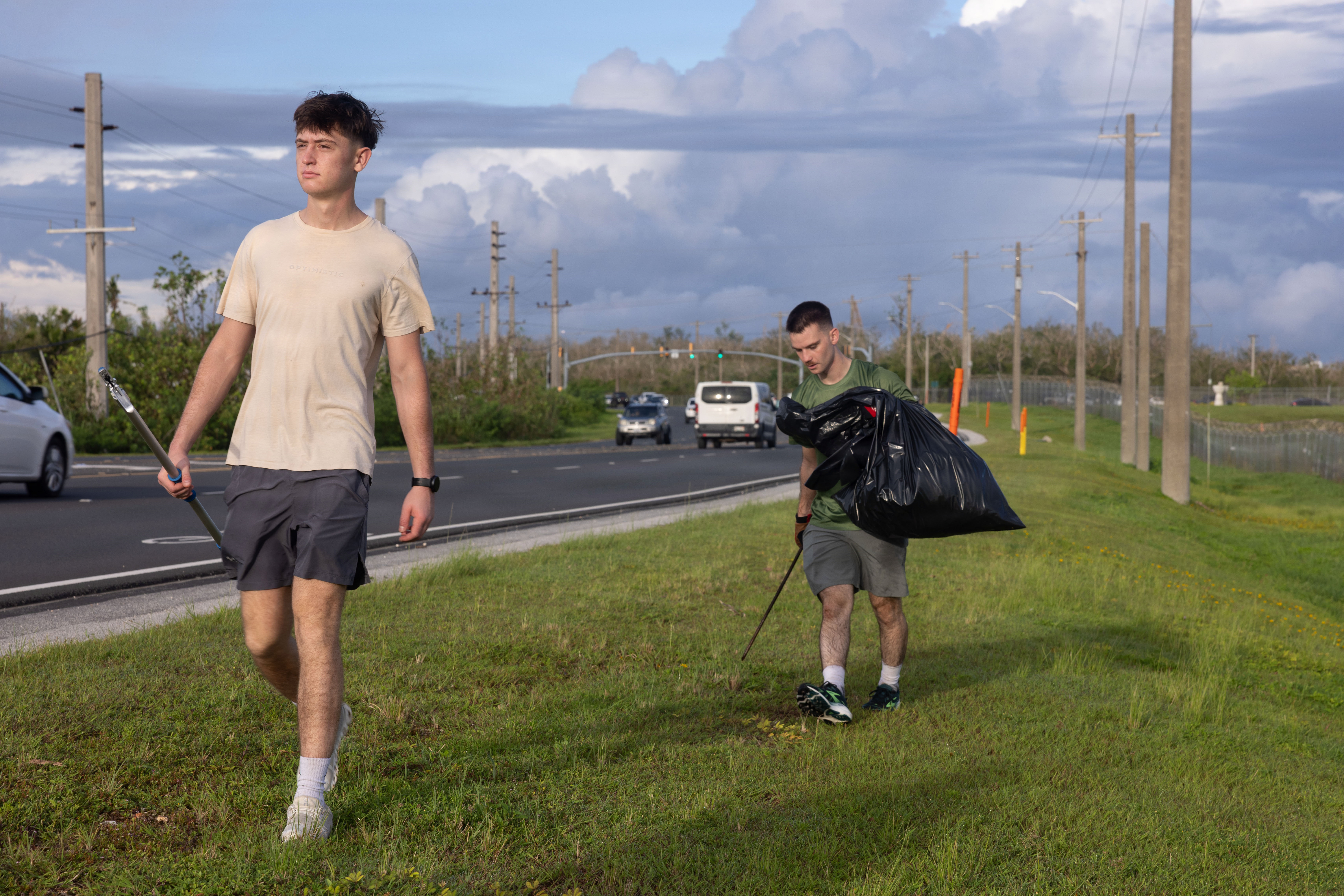 U.S. Marine Corps Lance Cpl. Mark Dvoskin, combat graphics specialist and Lance Cpl. Tanner Currin, combat graphics specialist, Headquarters Company, Marine Corps Base Camp Blaz, finish cleaning up the side of the road near the Brig. Gen. Ben Blaz Memorial Highway sign at Dededo, Guam, July 28, 2026. MCB Camp Blaz personnel strengthened community ties and supported Guam’s natural beauty through ‘Marines in the Wild’ program, while commemorating the one-year anniversary of the official Route 3 rename to Brigadier General Ben Blaz Memorial Highway. (U.S. Marine Corps photo by Pfc. Jayden Martinez)