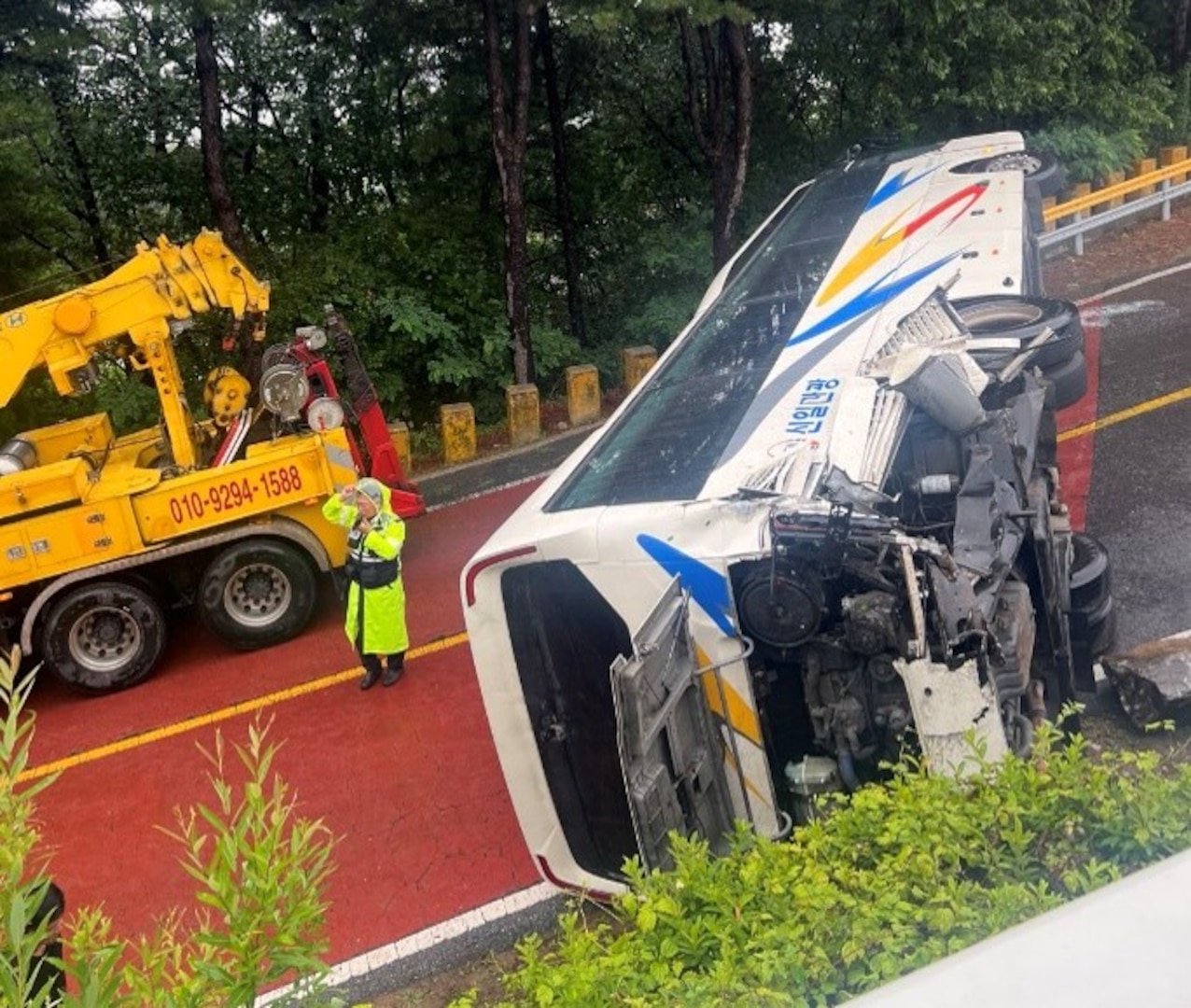 A tour bus sits overturned on a roadway in Paju, Republic of Korea, June 20, 2026. Off-duty U.S. Airmen and Soldiers sprang into action after the bus overturned, assisting injured passengers until emergency services arrived.