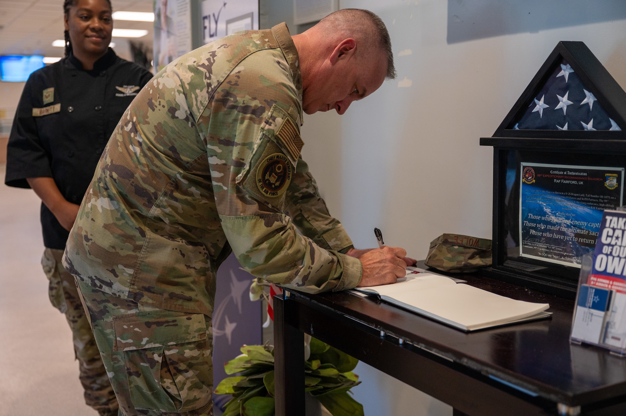 Chief Master Sergeant of the Air Force David R. Wolfe writes in the welcome book at the Contrails Dining Facility at Beale Air Force Base, Calif., Aug. 3, 2026.